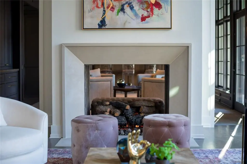 The two-sided gas log fireplace features a charming limestone mantel. 