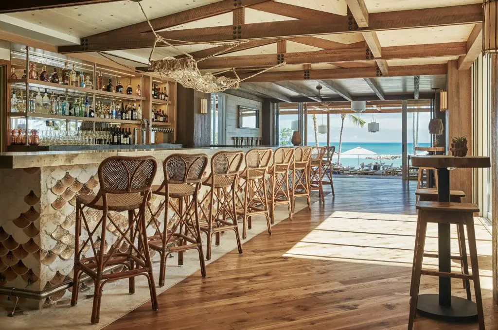 The restaurant has a large, custom bar with island-inspired elements. 