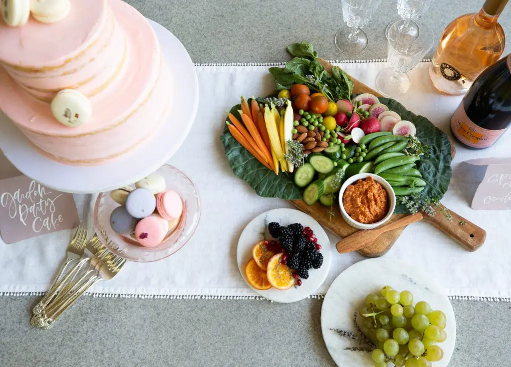 A colorful crudités platter by Marcia Smart, cake by Susiecakes, and macarons by Macaron by Patisse