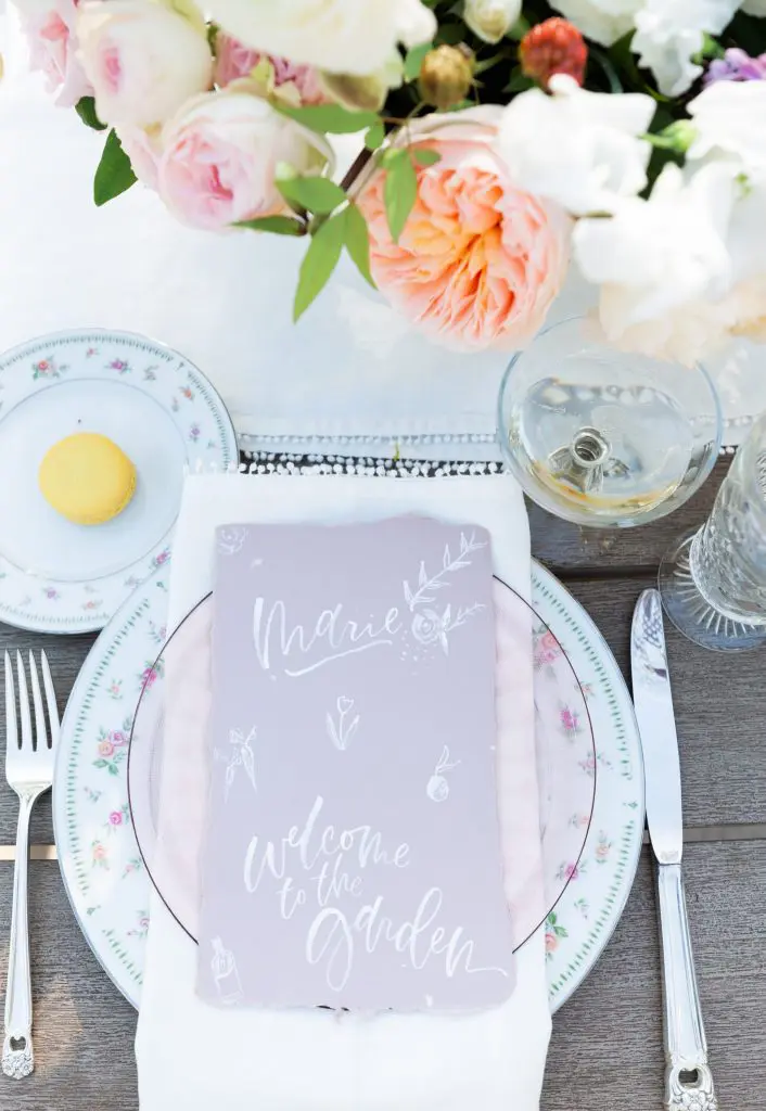 Meg Grant & Co calligraphed place cards with a sweet message in unexpected white ink atop lavender paper.