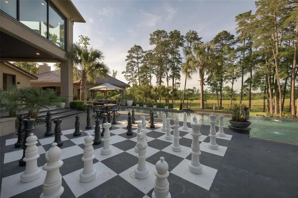 An oversize chess board is just one of the many outdoor amenities, like the al fresco kitchen. 
