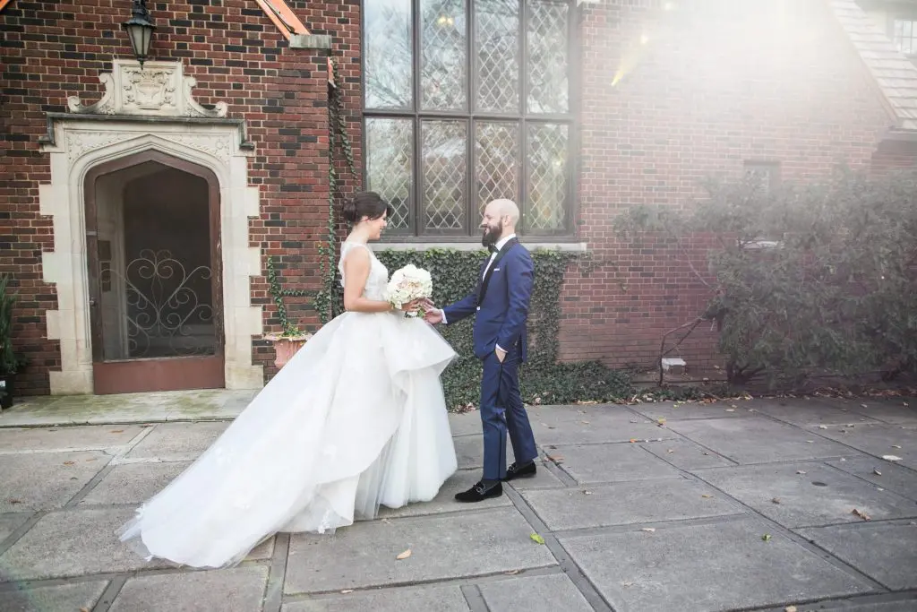 Bivins and Cone share a moment outside the church where they both attended school. Cone wears a custom Harper & Jones tuxedo (Photo by Samuel Lippke Studios)