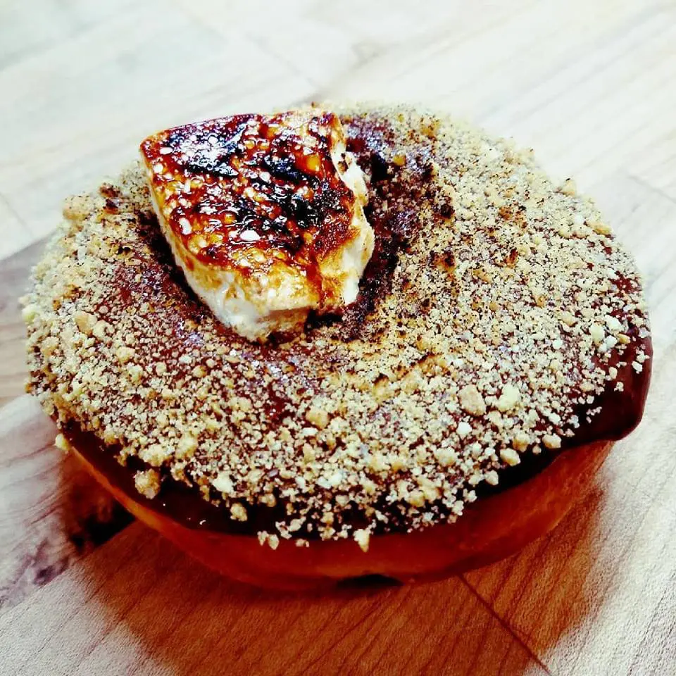 Hugs & Donut's S'mores donut is a delicacy with a chocolate pudding center and scorched marshmallow on top. 