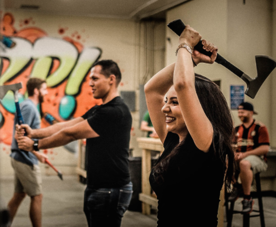Wind up, as professional demonstrate appropriate axe throwing technique; photo courtesy of Bad Axe Throwing