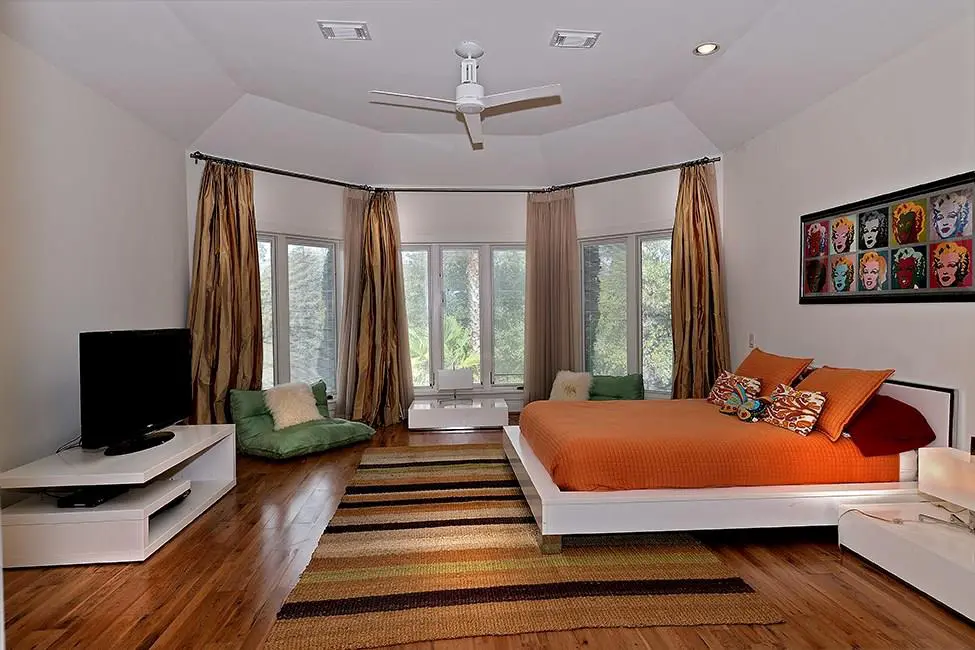 This bedroom is spacious and bright. 