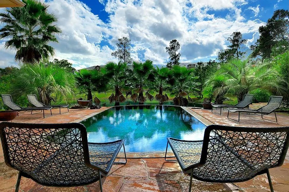 A pool, a lake — swimming opportunities abound at this house. 
