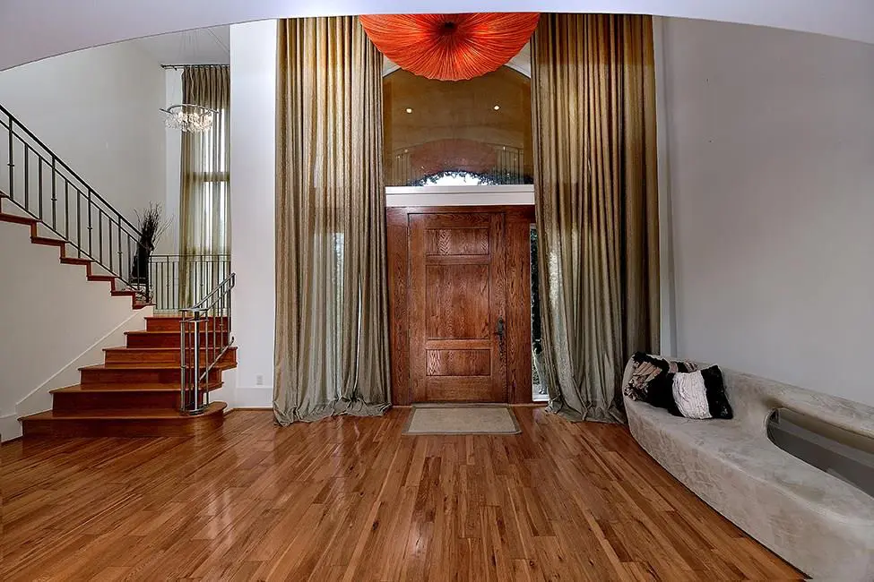 The grand foyer has soaring ceilings and a sweeping staircase. 