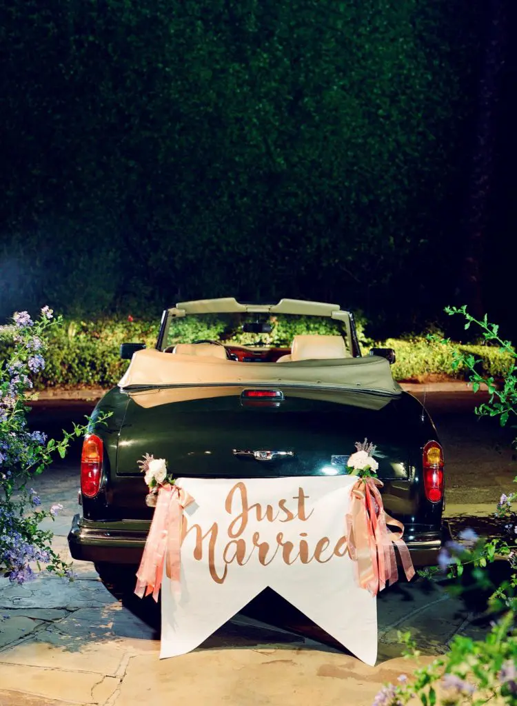 The couple departed in a vintage Hollywood-esque black car. (Photo by Jose Villa)