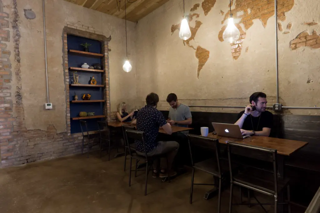 The team recycled elements from the original structure, such as reclaimed wood for chairs and tables.
