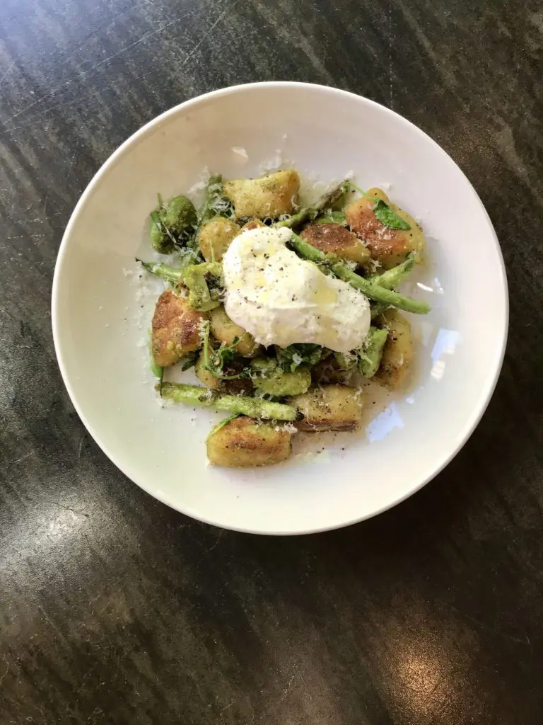 The pan-roasted potato gnocchi comes with a fresh basil pesto. 