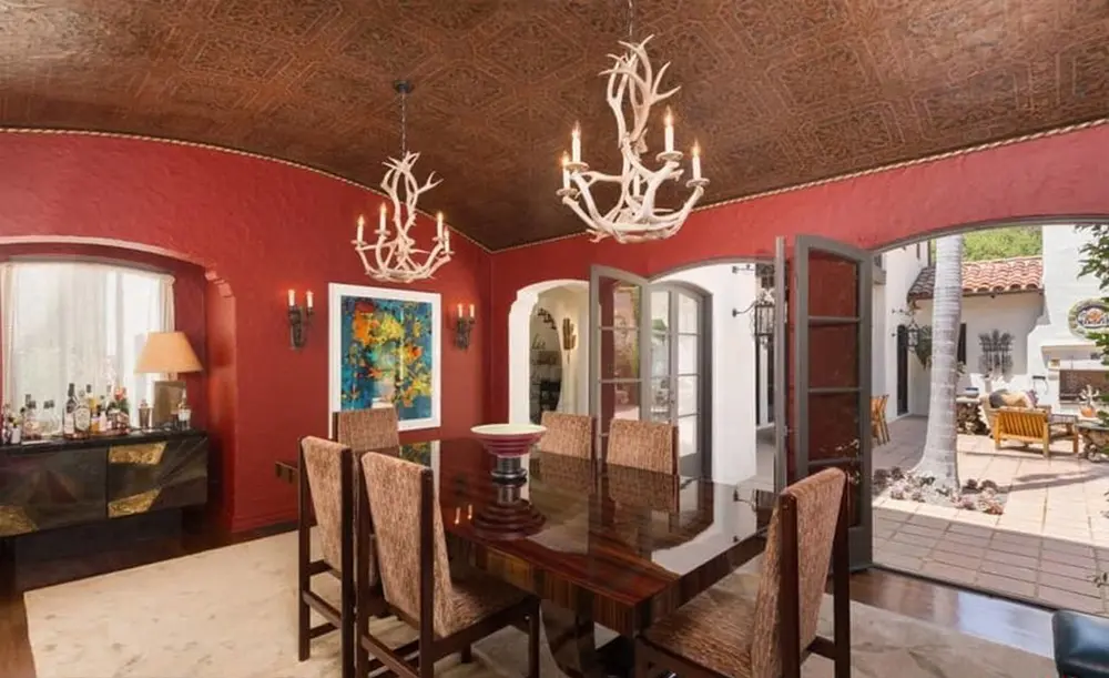 The antler chandeliers add an element of drama to the formal dining room. 