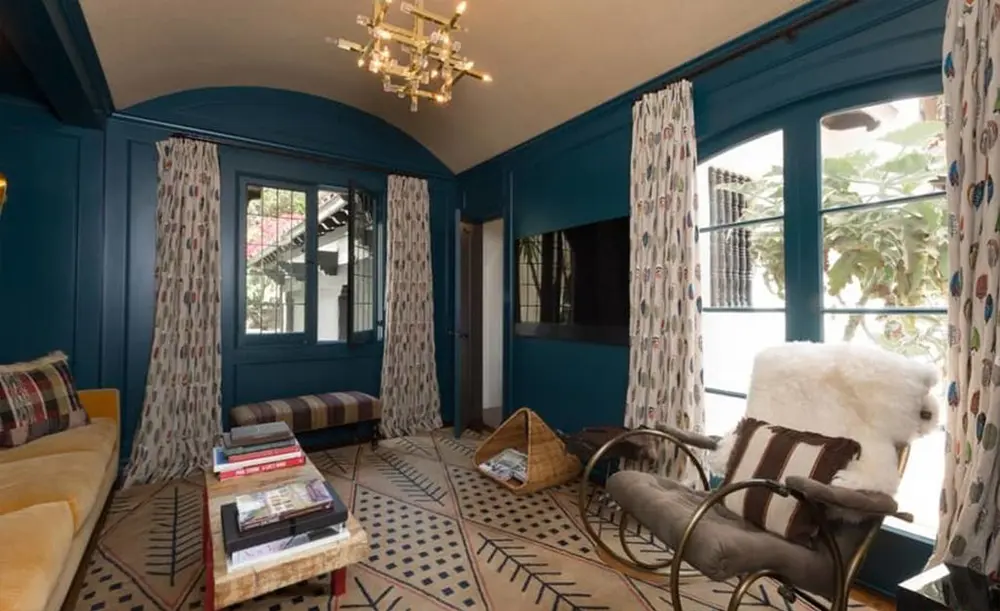 Rich blue walls add dimension to the den. 