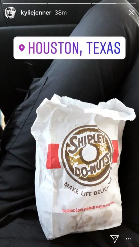 Travis Scott is teaching Kylie Jenner a thing or two about Houston. She's now eating Shipley's donuts.