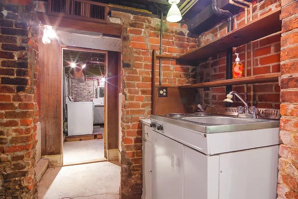 The basement kitchenette leads into the laundry room. 
