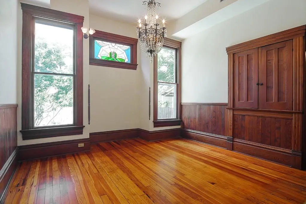The dining room boasts built-in China cabinetry and custom-stained glass. 