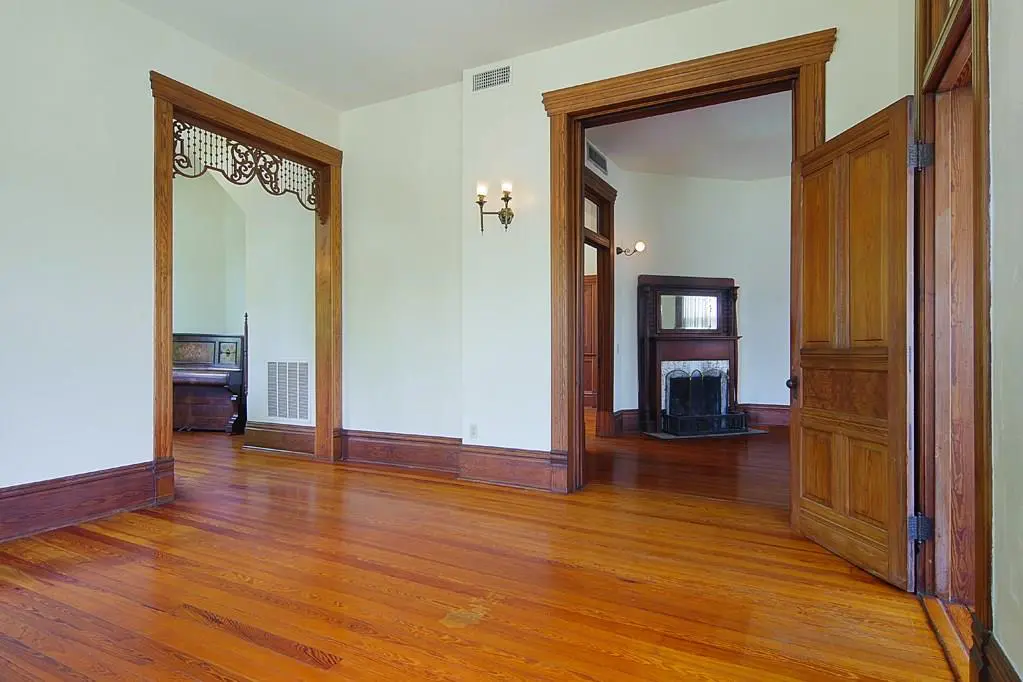 Vintage custom millwork graces the doorway of the parlor. 