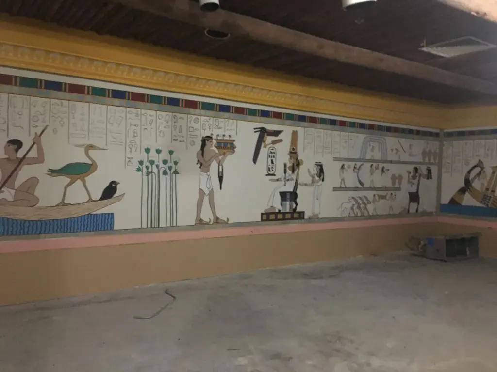 A painter is restoring each mural in Magic Island. 