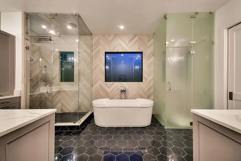 The master bath at 5519 Lynbrook features two glass showers and a stand-alone soaking tub. 