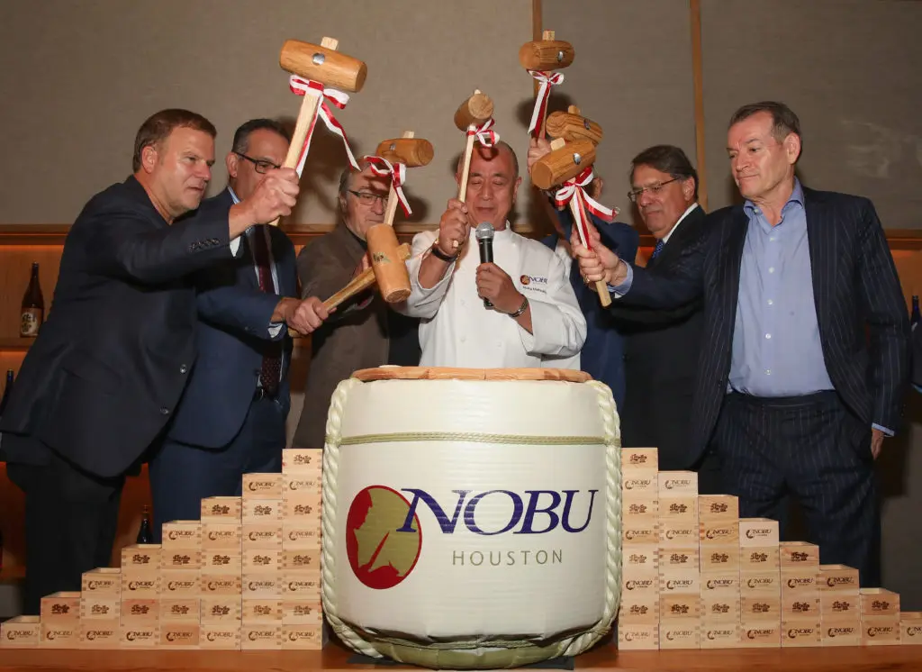 HOUSTON, TX - OCTOBER 18:  Nobu Founders Robert De Niro, Chef Nobu Matsuhisa, Meir Teper and friends break open a 5-gallon sake barrel at the Nobu Houston Sake Ceremony on October 18, 2018 in Houston, Texas.  (Photo by Rick Kern/Getty Images for Nobu)