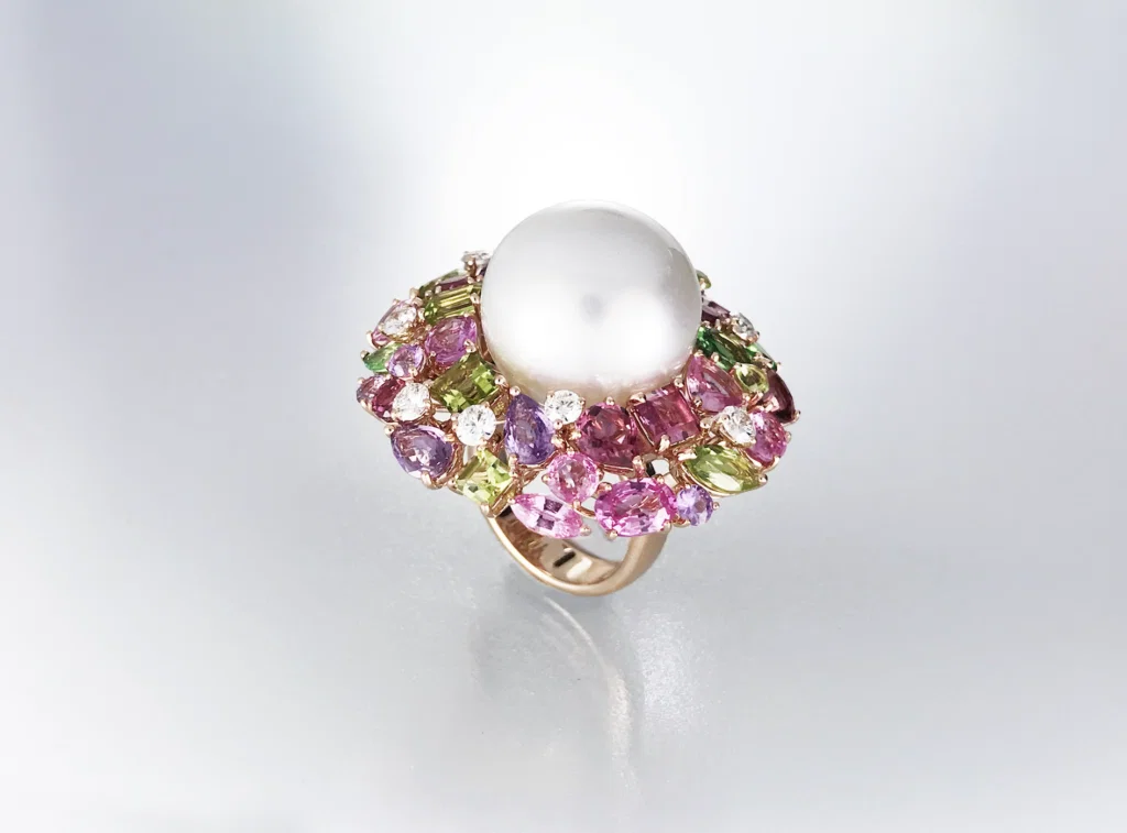 Australian South Sea Pearl cocktail ring surrounded by myriad of gemstones and diamonds in 18 karat yellow gold