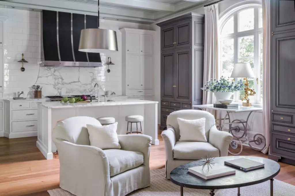 Although Kasler kept the kitchen tailored--- a highly functional work space in white with weather gray armories--they did dress it up more than usual to suit the client's lifestyle. Photo by Peter Vitale.