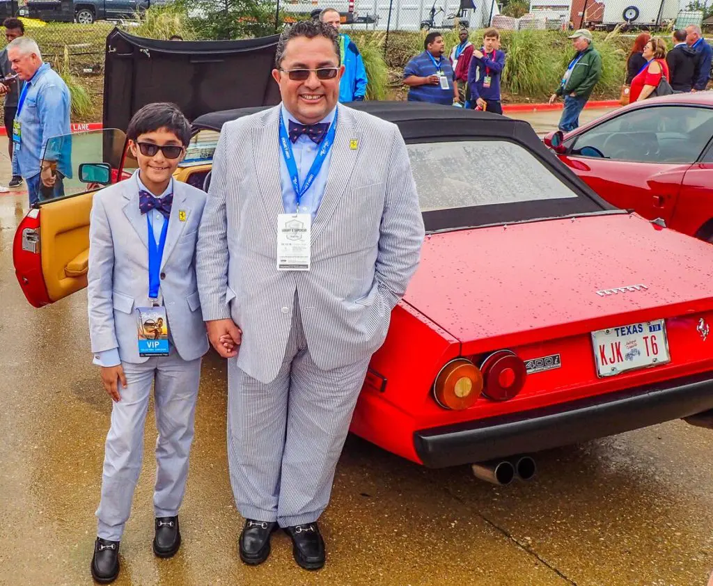 This dapper father-and-son duo stood in front of the family's Ferrari. 
