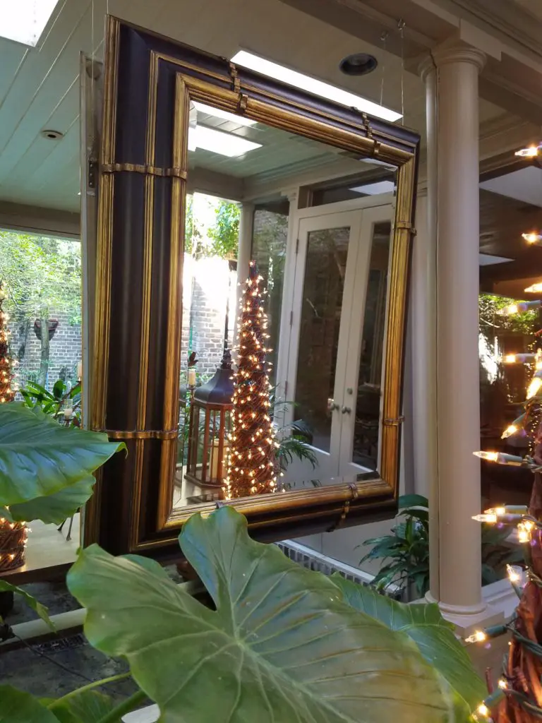 A mirror hangs outside, atop a wall of mirrors at the stately Upper Kirby townhome of Munson Mirrors founder Carol Isaak Barden. Photo courtesy Carol Isaak Barden.