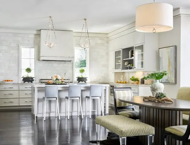 The kitchen features custom cabinetry, iron doors and lucite pulls. 