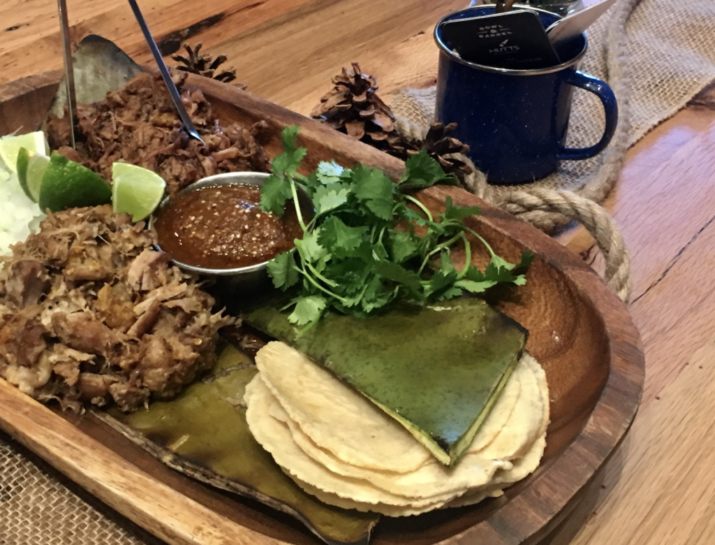 The carnitas tacos are prepared with orange peel for a zesty flavor. 