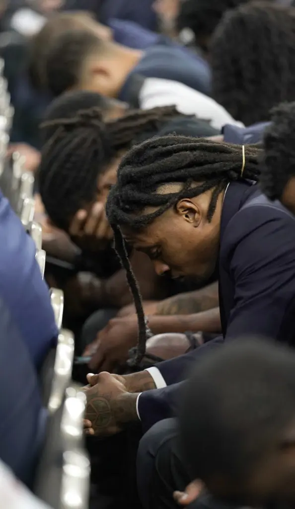 Houston Texans receiver DeAndre Hopkins bows his head during a prayer at a public celebration of life for Houston Texans owner Robert C. McNair at NRG Stadium. (AP Photo/David J. Phillip, POOL)