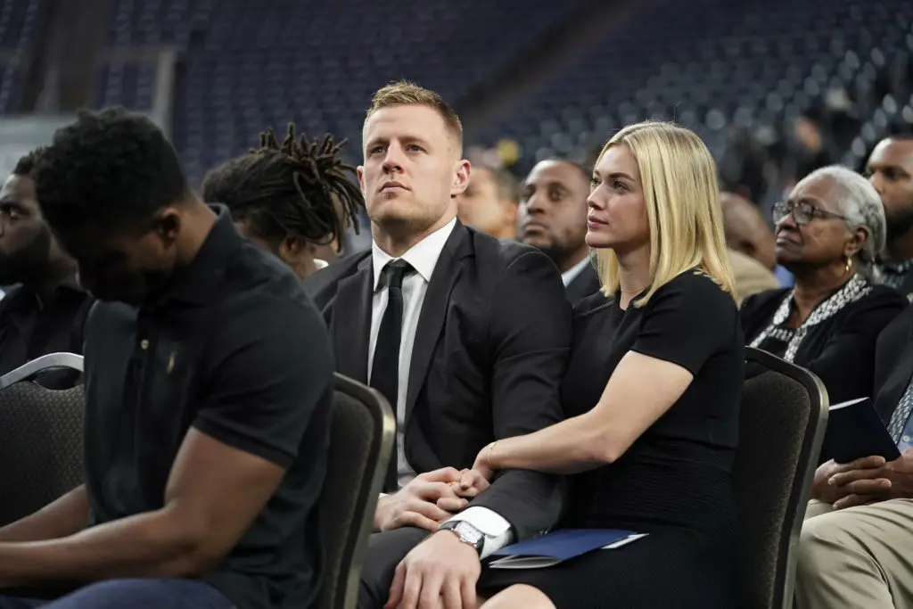 J.J. Watt and his girlfriend, Houston Dash player Kealia Ohai watch a video tribute during a public celebration of life for Houston Texans owner Robert C. McNair at NRG Stadium. (AP Photo/David J. Phillip, POOL)
