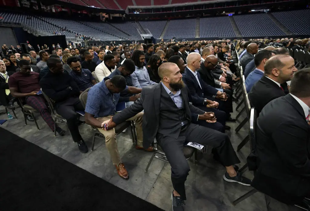 Houston Texans players pray during a public celebration of life for Houston Texans owner Robert C. McNair at NRG Stadium. (AP Photo/David J. Phillip, Pool)