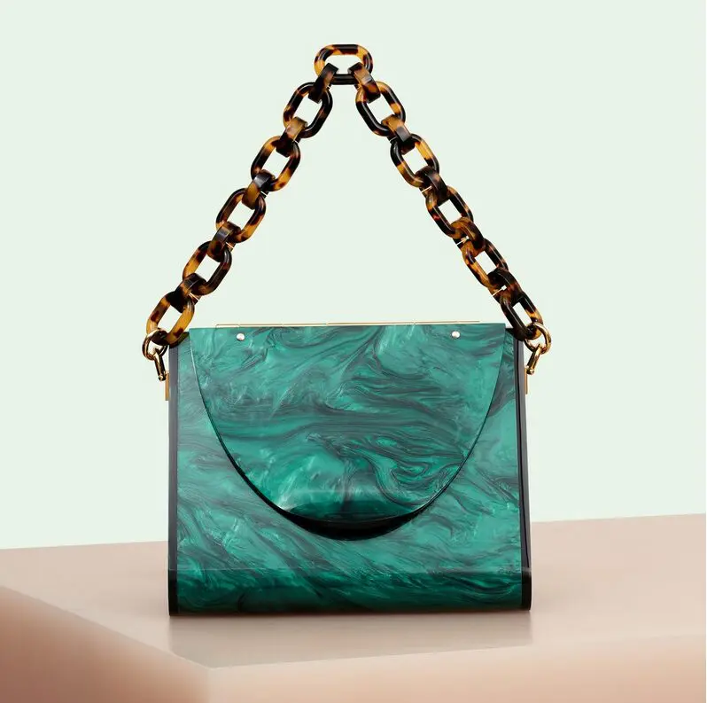 Yule-time lucite: An ode to '50s and '60s glamour, American brand Edie Parker has revived this lost look, with sculptural acrylic handbags that are both polished and precise. Triangle bag in emerald, $1,495, through Edie Parker. (edie-parker.com) 