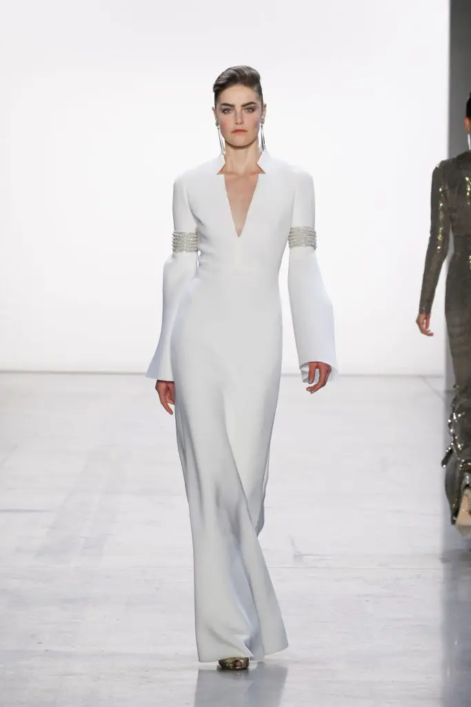 Badgley Misckha white gown with silver arm trim (Photo by Badgley Mischka)
