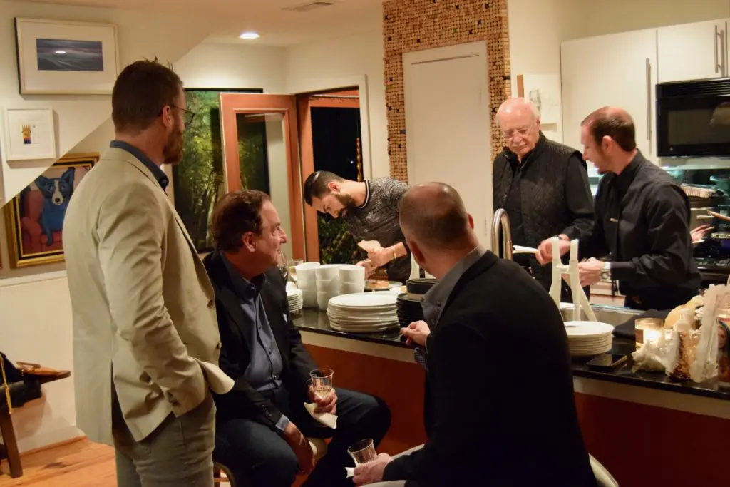 The gents gather in the kitchen as Fady Armanious prepares dinner. (Photo by Shelby Hodge)