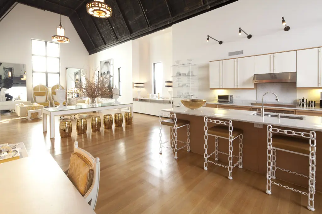 The kitchen, which flows into the dining and living areas, features Poggenpolh cabinetry and chairs designed by Loya featuring Chanel-like chain structure. (Photo by Julie Soefer)