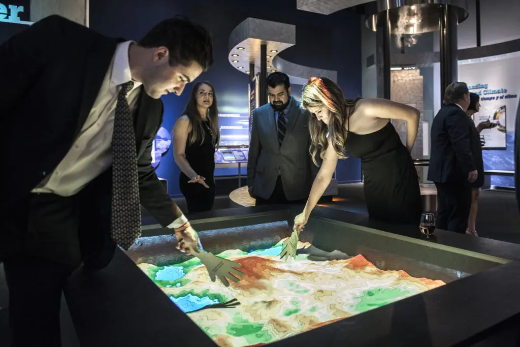 Playing in an augmented reality sandbox (Photo by Turk Studio)