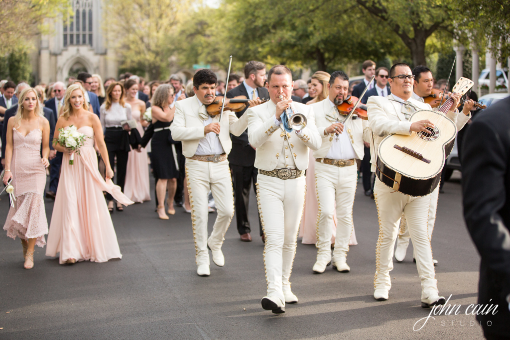 A mariachi band serenaded the guests as they paraded from the church to the reception.  (Photo by John Cain Photography)