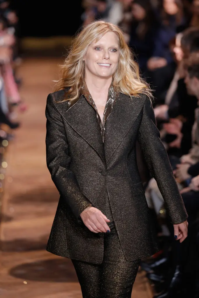 Model Patti Hansen closes the Michael Kors runway show in a metallic jacket with wide lapels and matching pants. (Photo by JP Yim/Getty Images for Michael Kors)