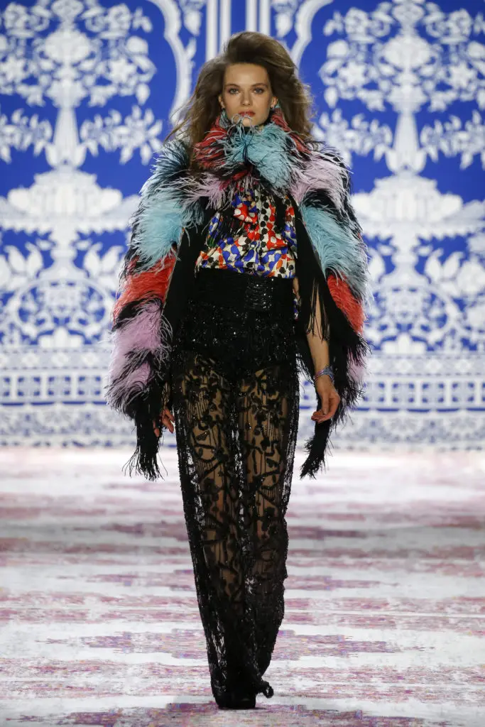 Naeem Khan black embroidered pants, mosiac print blouse, multicolor feather shawl. (Photo by Naeem Khan)
