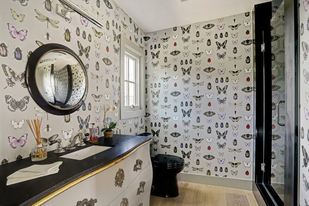 A handsome bath off the library with designer wallpaper.