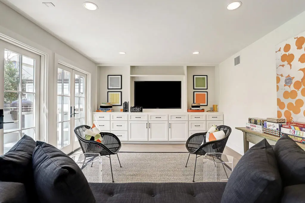 The gameroom features an entertainment center and access to the backyard.