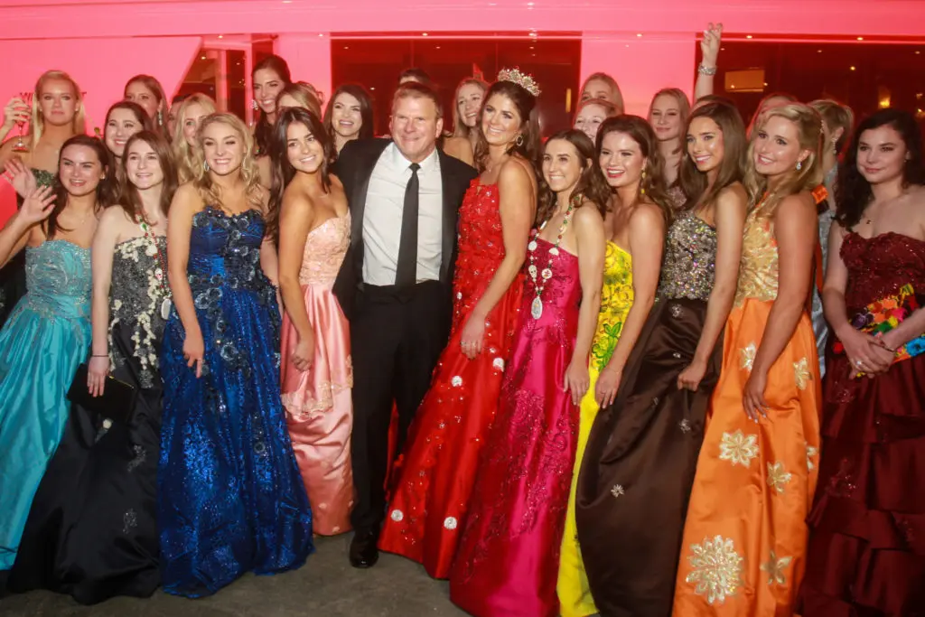 Knights of Momus duchesses and queen Blayne Fertitta flank host Tilman Fertitta at The San Luis Salute to Mardi Gras in Galveston.  (Gary Fountain photo)