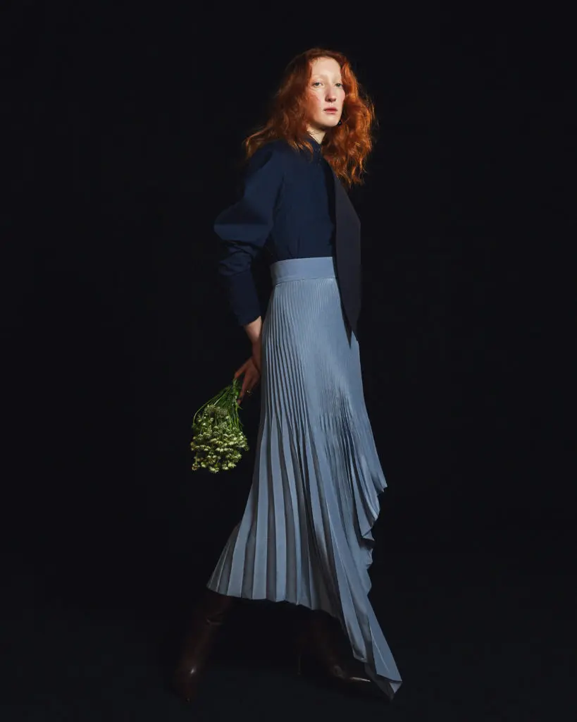 Amir Taghi pleated pale blue skirt and navy tie blouse with Elizabethan sleeves. (Photo by Amir Taghi)