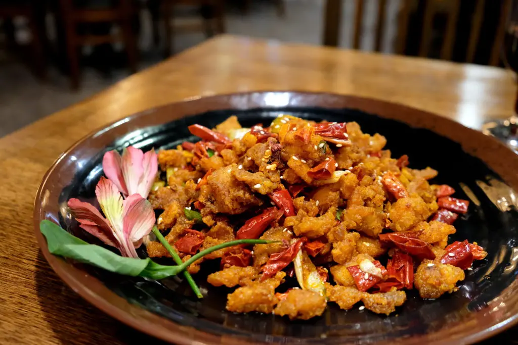  Wula Buhuan's spicy chicken cubes leave a hot impression. (Photo by Mai Pham)