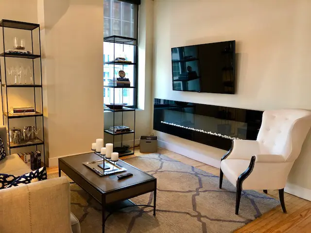 A vertical fireplace adds glamour to this St. Germain reidence.