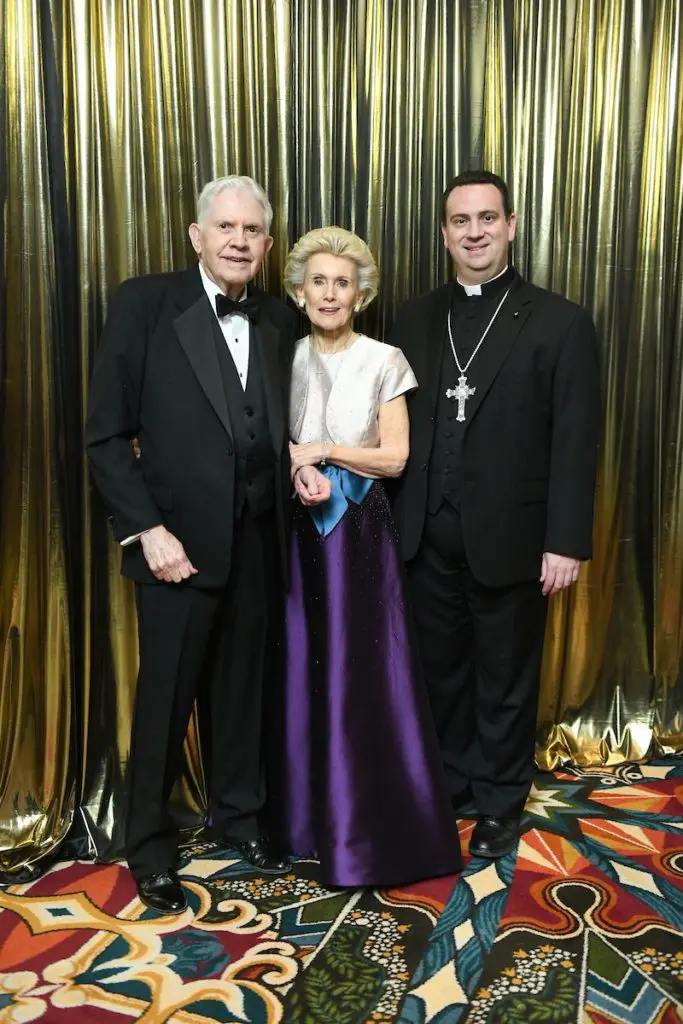 Carl & Lois Davis and the REv. Steven J. Lopes at the University of St. Thomas Mardi Gras ball.