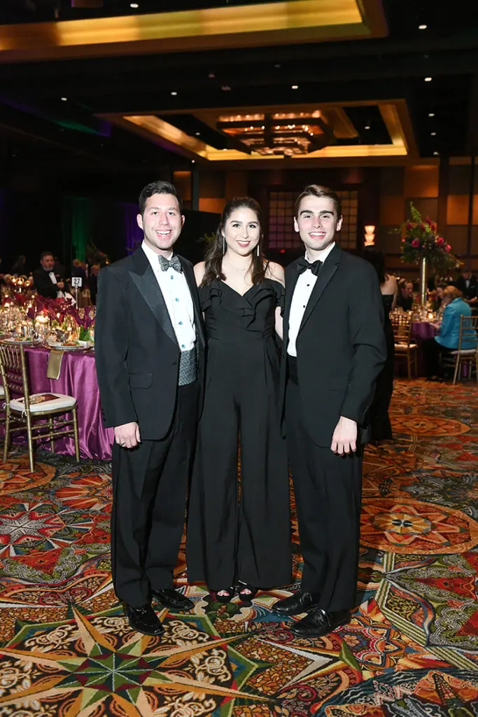 Ryan & Rebecca Reza, Thomas Forster at the University of St. Thomas Mardi Gras ball.