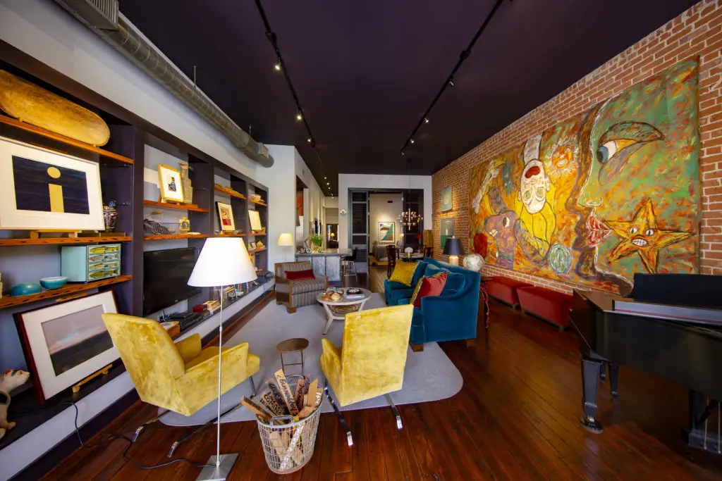 A modern mural stretches across the brick wall in the living area of this W.L. Foley Building apartment.