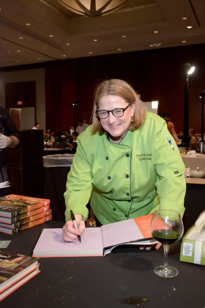 Elizabeth Stone autographs her book, 'An Invitation to Entertaining,' at the Youth Development Center Bon Vivant (Photo by David Postma, Genesis Photographers)